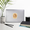 Load image into Gallery viewer, Laptop with a 'HOWDY' sticker on a desk with a plant, pencils, and books.
